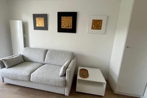 a living room with a couch and a table at Studio with balcony and pool in La Baule in La Baule