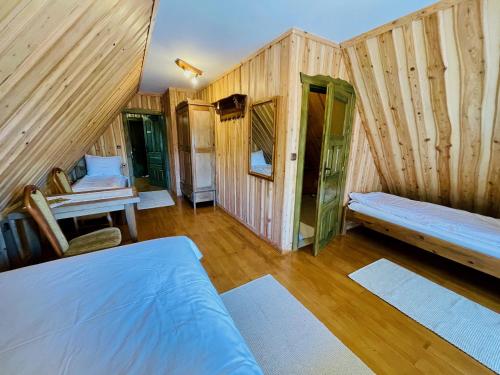 a room with a bed and a bench in it at Agroturystyka Na Górze - Obrocz 116A in Obrocz