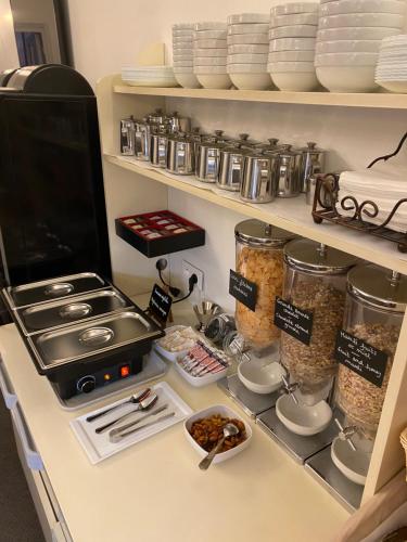 a kitchen counter with a stove and some food at Hôtel Le Mozart in Aix-en-Provence