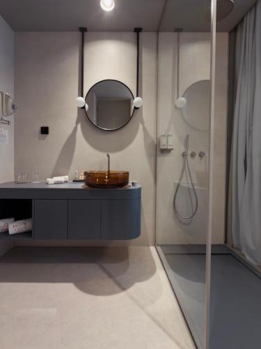 a bathroom with a sink and a mirror at Moon & Sun Funchal in Funchal