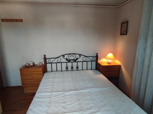 a bedroom with a bed and a lamp on a table at Fiorela Gest House in Kalabaka