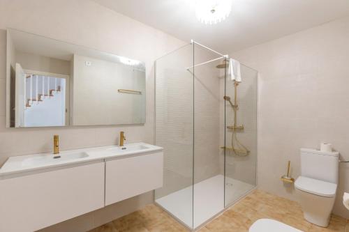 a white bathroom with a sink and a shower at Villa Sea Lights 89b in Son Bou