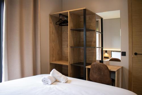 a bedroom with a bed and a desk and a chair at LA TIERRUCA HOMES in Barcenaciones