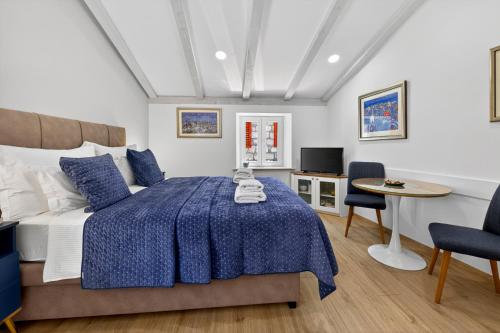 a bedroom with a bed and a table and chairs at Solis Rooms Old Town in Dubrovnik