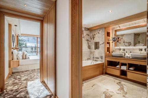 a bathroom with a tub and a sink at Hotel Annapurna in Courchevel