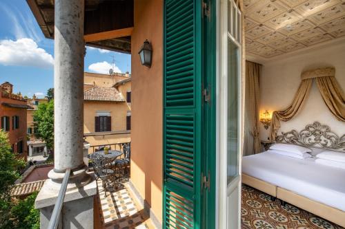 a bedroom with a bed on a balcony at Hotel Aventino in Rome