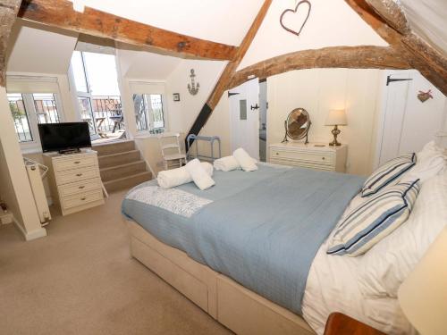 a bedroom with a large bed and a tv at Tovah in Yarmouth
