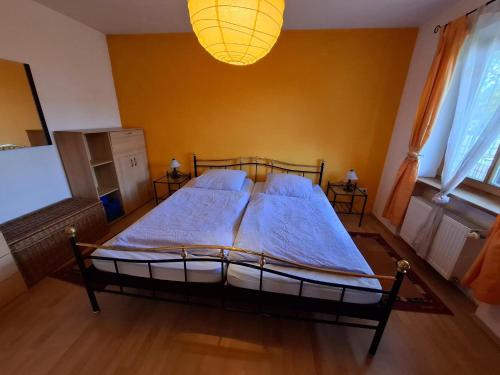 a bedroom with a large bed with a chandelier at FW Körner in Zwiesel