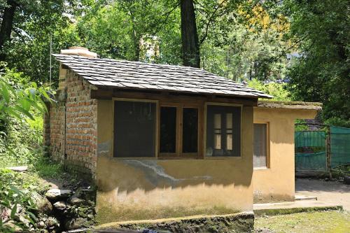 a small building with a roof on top of it at NotOnMap- Saal River Homestay in Chamba