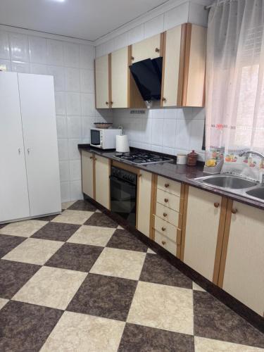 a kitchen with a checkered floor at Casa en Manuel in Manuel