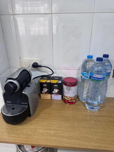 a coffee maker and bottles of water on a counter at Casa en Manuel in Manuel