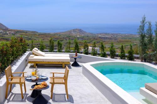 a patio with a pool and a table and chairs at Avelora Suites in Pyrgos