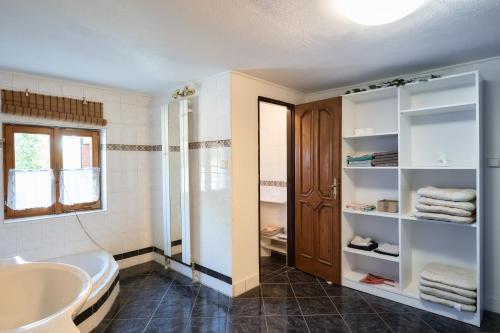a bathroom with a white tub and a sink at CHALUPA in Hosty