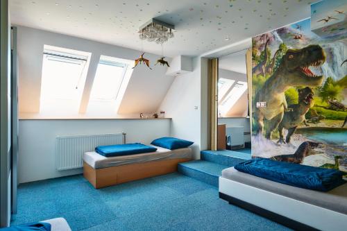 a bedroom with two beds and a mural of a dinosaur at CHALUPA in Hosty