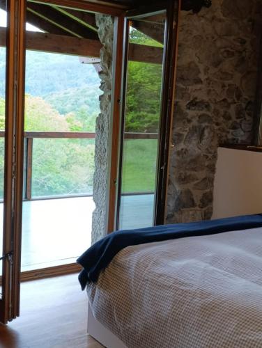 a bedroom with a bed and a large window at Casa con encanto in Arredondo