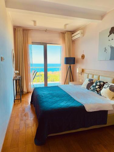 a bedroom with a bed with a view of the ocean at Altezza Premium Breathtaking Sea Views in Budva