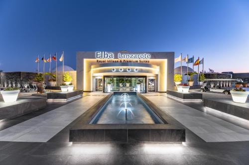 a lobby of a hotel with a fountain in the middle at Elba Premium Suites - Adults Only in Playa Blanca