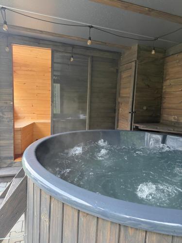 a large jacuzzi tub sitting in a room at 10 osobowy Bania House Okuninka rowerek wodny jacuzzi sauna 1200 m do centrum Okuninki 6 km do Włodawy in Włodawa