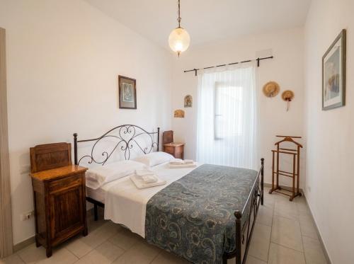 a bedroom with a bed and a table and a window at Da nonno Carlo Lakeview - By BorgoLago in Capodimonte