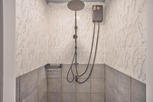 a shower with a shower head in a bathroom at Urban Pod Capsule Hostel in Bangkok