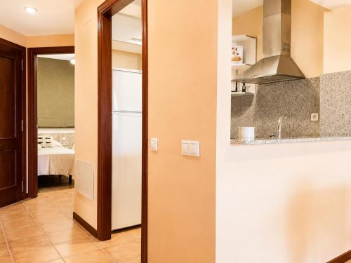 a kitchen with a white refrigerator in a room at Apartamento L'Eucaliptus, Delta del Ebro in Amposta