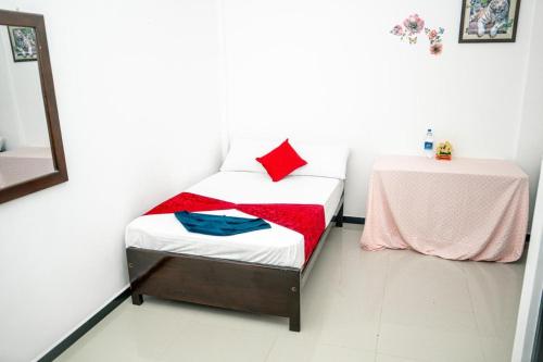 a small room with a bed and a table at Alles garden New Seaside in Trincomalee
