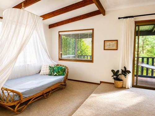 a room with a hammock in a house at Thrums Bush Retreat in Upper Orara
