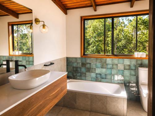 a bathroom with a tub and a sink at Thrums Bush Retreat in Upper Orara