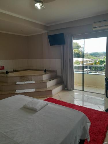 a bedroom with a bed and stairs with a view at Florença Hotel in Quedas do Iguacu