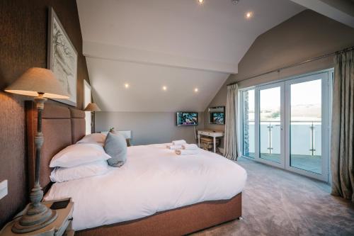 a bedroom with a large bed and a large window at The Penthouse @ Carus Green in Kendal