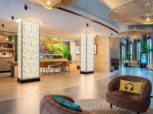 a living room with two chairs and a table at ibis Dubai World Trade Centre in Dubai