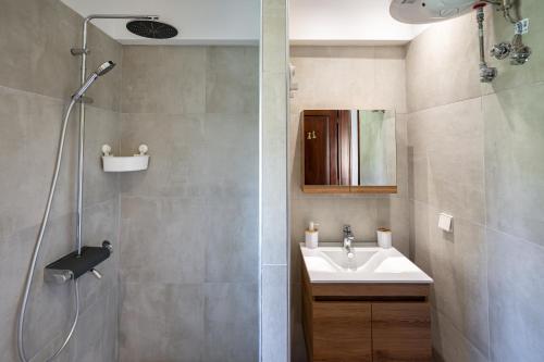 a bathroom with a sink and a shower at Fourka Garden Villas in Fourka