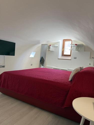 a bedroom with a red bed and a table at Casa Pont1 Historic Pontone near Amalfi & Ravello in Scala