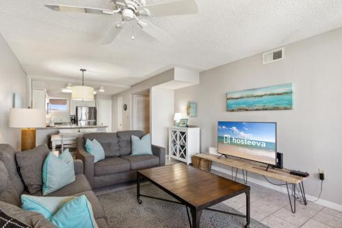 a living room with a couch and a tv at Buena Vista Condominiums in Gulf Shores
