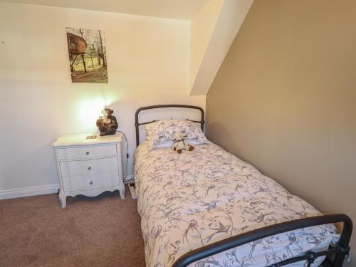 a bedroom with a bed with a teddy bear sitting on it at 4 Eve Street in Louth