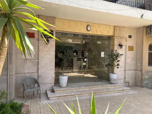a lobby of a building with a chair and a window at Maison de Lama - Expat friendly, AirCon, Garden access in Cairo