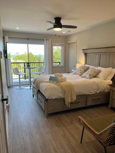 a bedroom with a large bed and a balcony at Tobermory Tides bed and breakfast in Tobermory