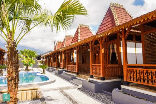 a resort with a swimming pool and a building at Instay Villa Dieng Kademangan in Wonosobo