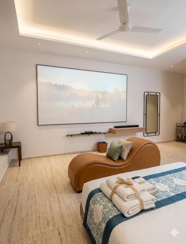 two beds in a room with a large screen at Hotel VD Rooms Althan in Surat