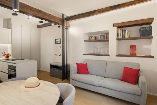 a living room with a couch and a table at Iseo Vicolo Portelle - indoor private parking & bike storage in Iseo