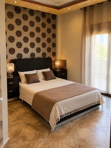 a bedroom with a large bed and a window at Marsia House in Vathí