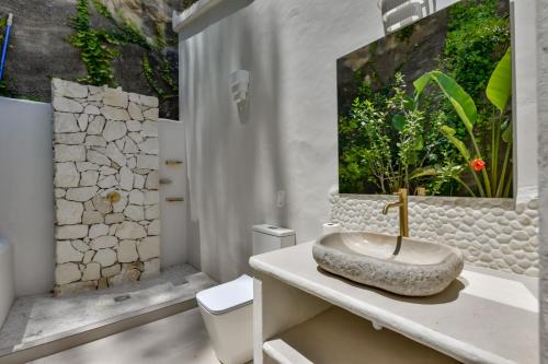 a bathroom with a sink with a painting on the wall at Caray - Managed by Almarina Villas in Benissa