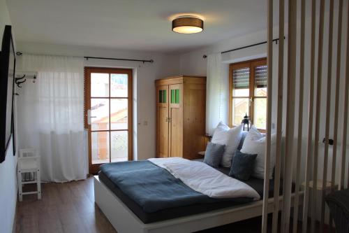 a bedroom with a bed with blue sheets and pillows at Fewo Obermoos in Teisendorf