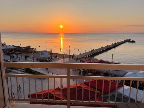 a view of a marina at sunset from a balcony at Vento di Mare in Perea