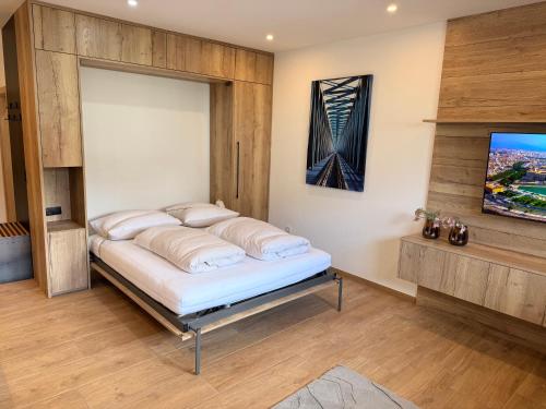 a bed in a room with a wall at Excelsior Top 17 Alpenherz in Seefeld in Tirol