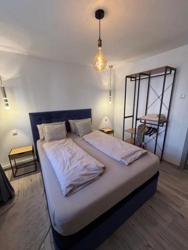 a bedroom with a large bed with white sheets at Ralfi in Alba Iulia