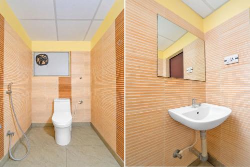 a bathroom with a sink and a toilet at FabHotel Sca - Gandhipuram in Coimbatore
