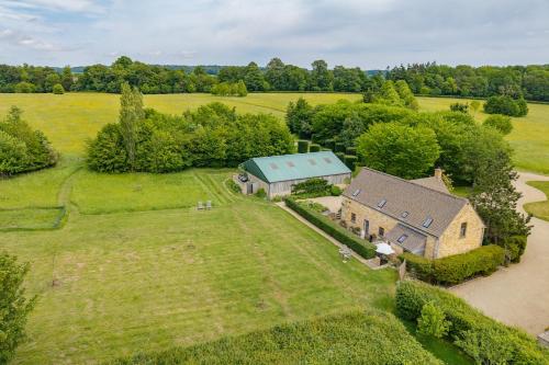an aerial view of an old house with a green roof at Claytons Hideaway in Adlestrop
