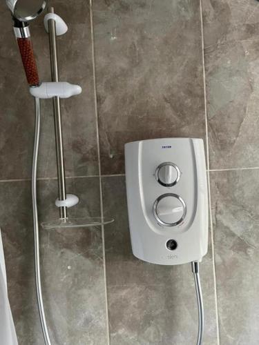 a soap dispenser in a shower in a bathroom at 3 Bedroom Flat - Sleeps 6 - Free Parking in Kirkcaldy