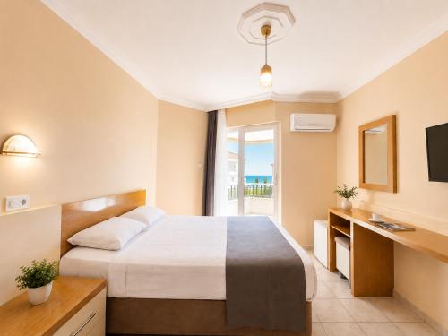 a hotel room with a bed and a window at Yaman Life Hotel in Alanya